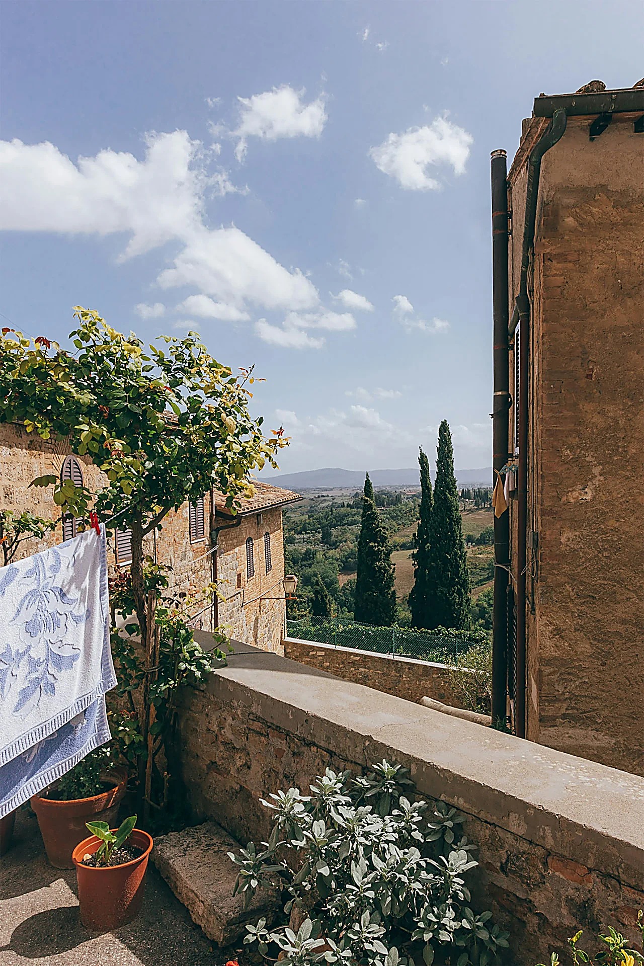 Tuscan village terrace overlooking cypress hills